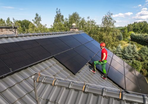 professional-worker-installing-solar-panels-roof-min